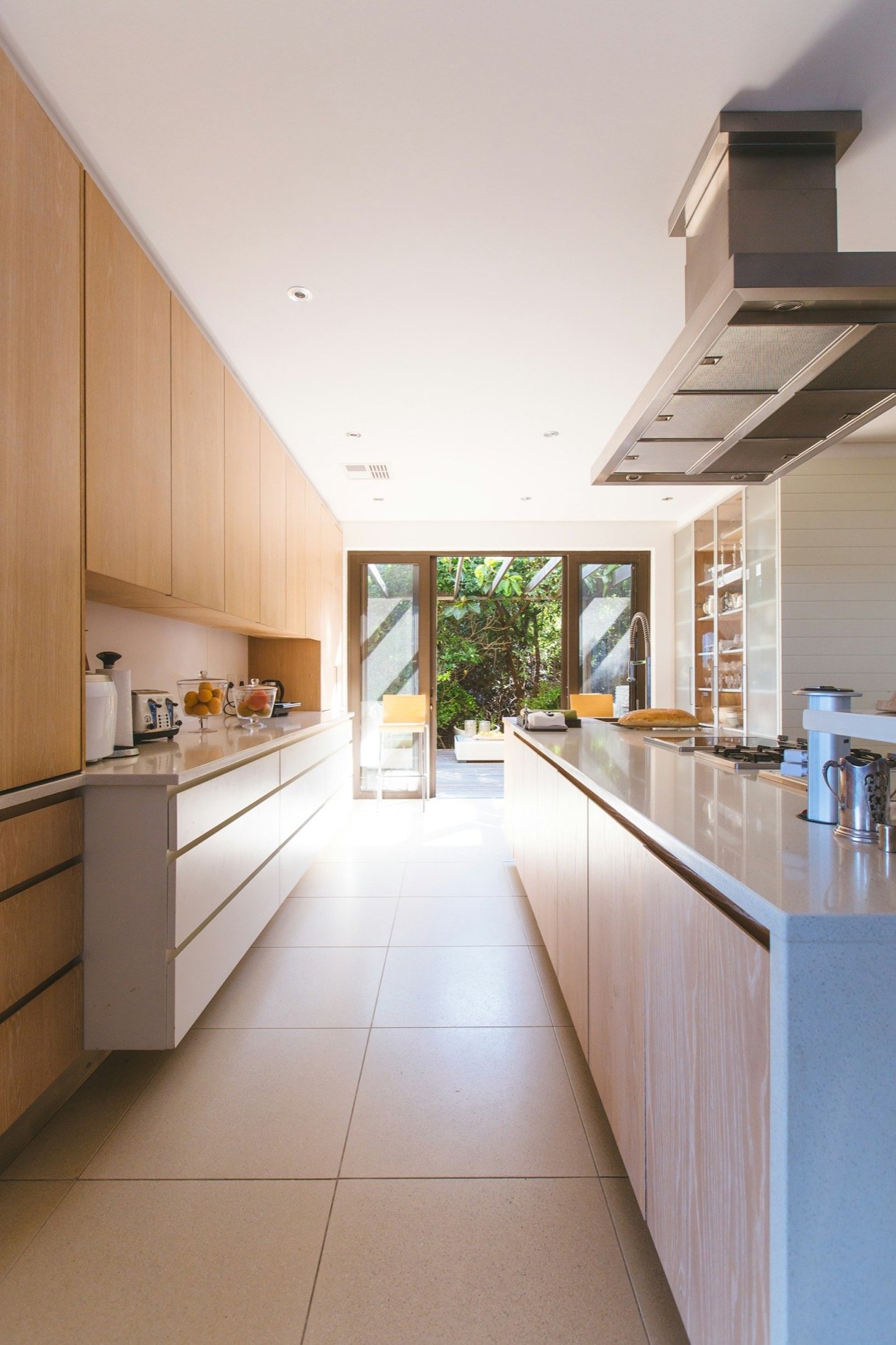 Remodeled kitchen with sage cabinets and vaulted wood ceiling