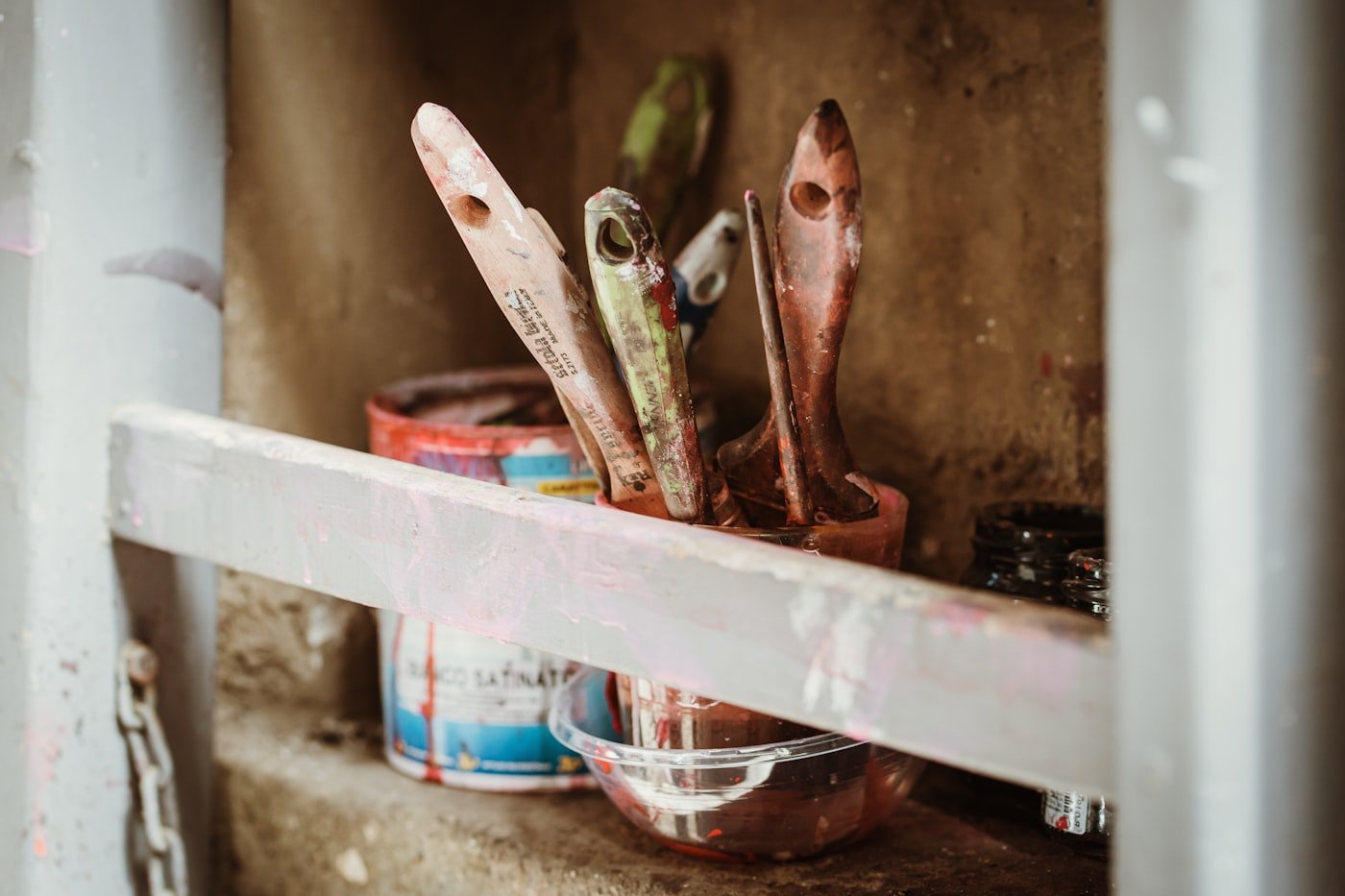 Paint cans and brushes prepared for a job